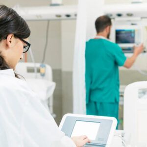 healthcare training grad using EKG machine