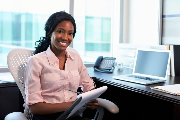 A female medical office specialist in an office after medical office specialist training.