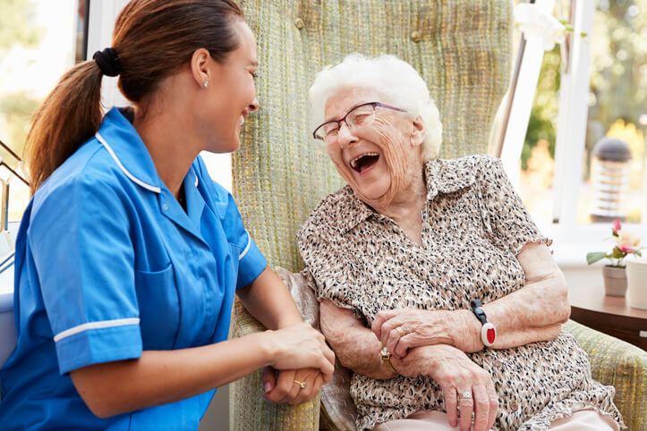 A smiling patient concierge with a smiling patient after healthcare training
