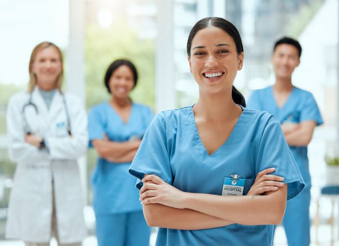 A medical office specialist standing together with her team